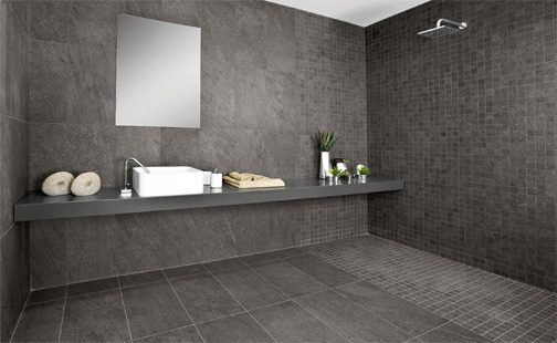 a wetroom with dark tiling