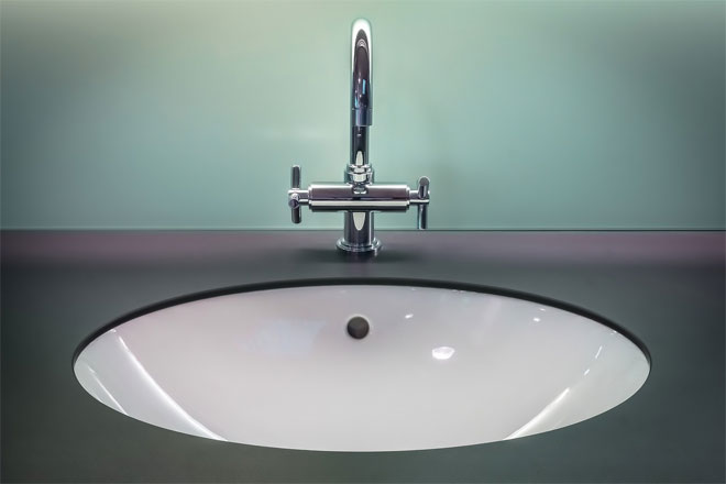 A stylish mixer tap and white bathroom basin