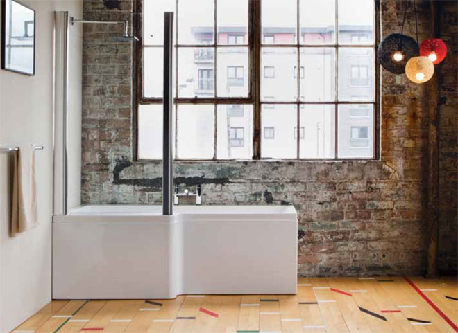 Luxury P shape bath in front of an interior brick wall