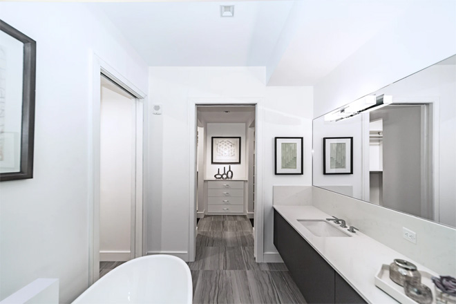 A stylish white bathroom with grey floor tiles